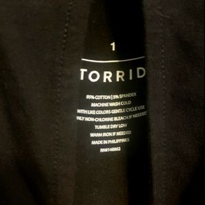 A black long sleeve peek- a- boo shoulder shirt